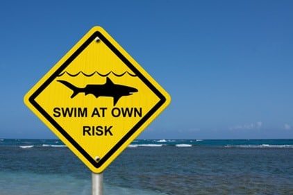 Use caution when swimming because sharks are present